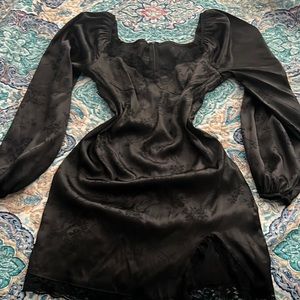 Figure hugging dress, black with lace detailing on the edges.